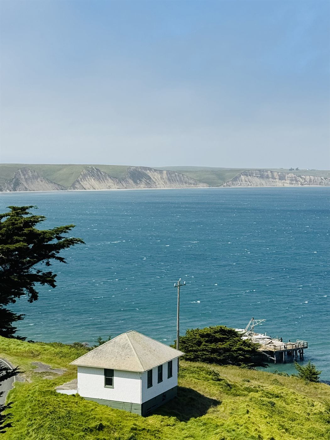 Point Reyes coast with a white house above the water